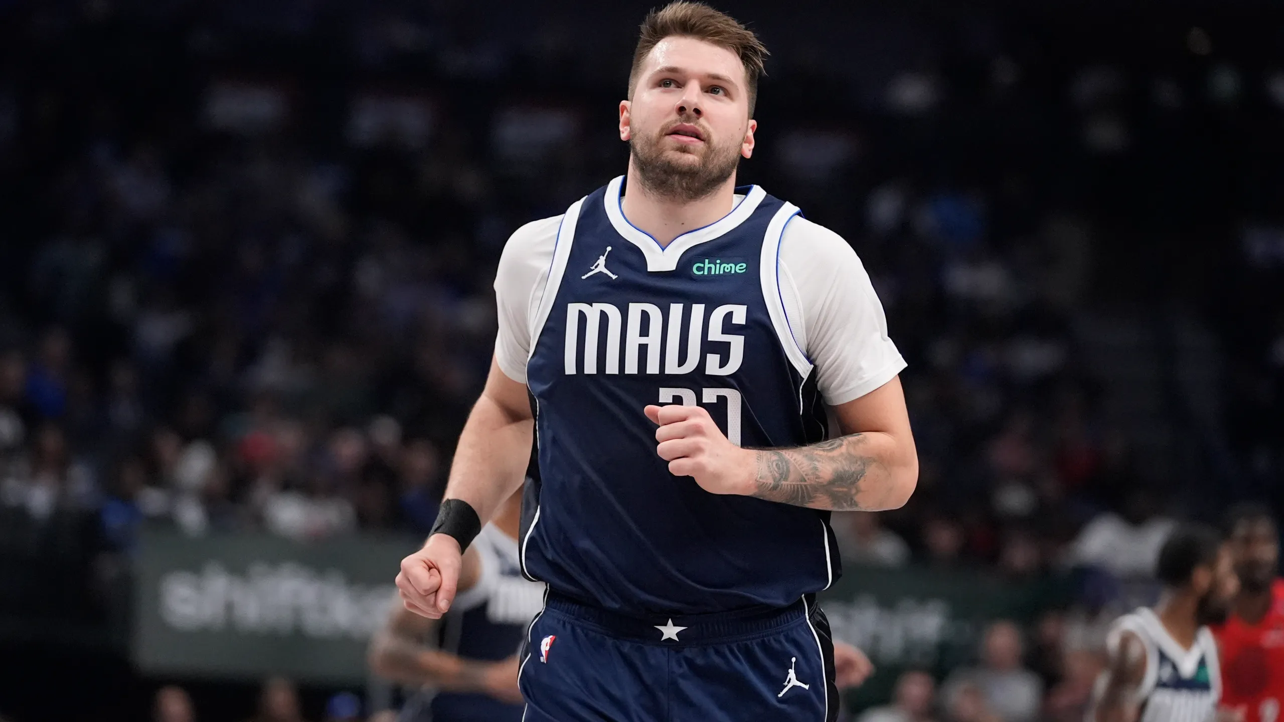 Luka Dončić making a play on the court during an NBA game.